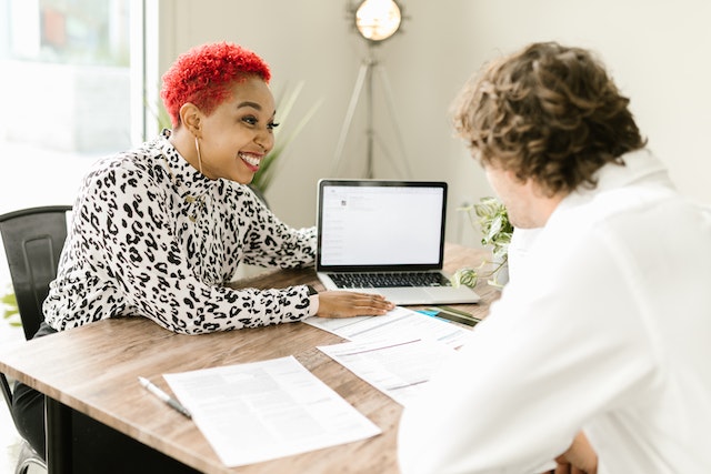 red haired property manager looking over a tenants credit report